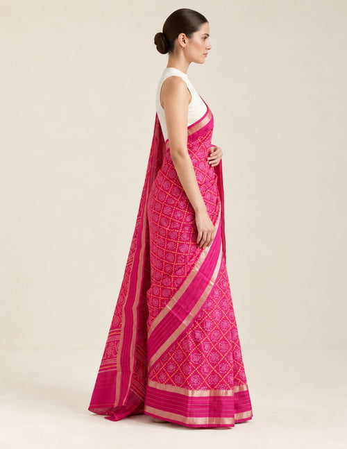 Fuchsia patterned saree displayed on a model, side view