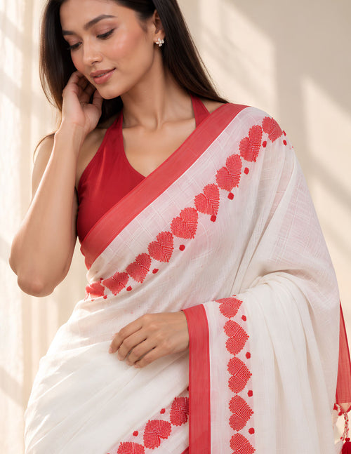 White and red handwoven cotton saree detail