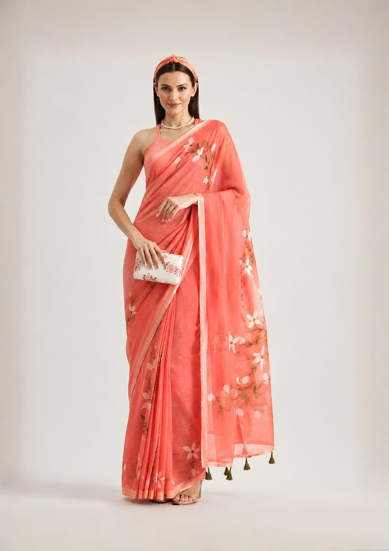 Coral floral saree with white floral motifs and tassel-detailed pallu